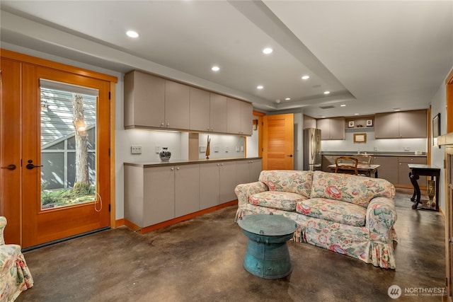 living room featuring a tray ceiling and plenty of natural light