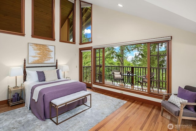 bedroom featuring wood-type flooring, high vaulted ceiling, and access to outside