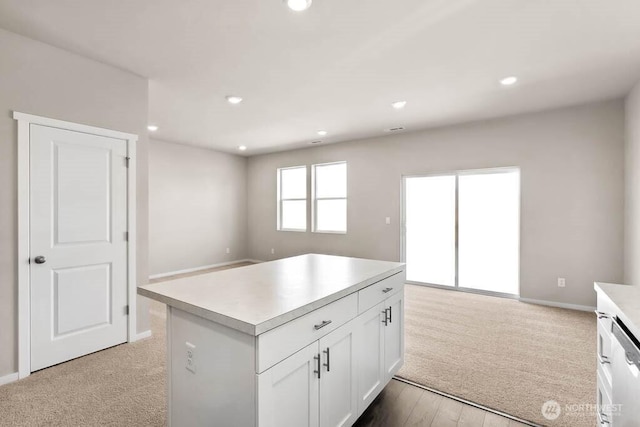 kitchen featuring white cabinetry, light countertops, recessed lighting, and stainless steel dishwasher