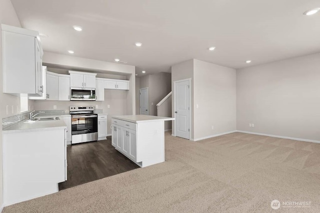 kitchen featuring white cabinetry, recessed lighting, carpet, and stainless steel appliances