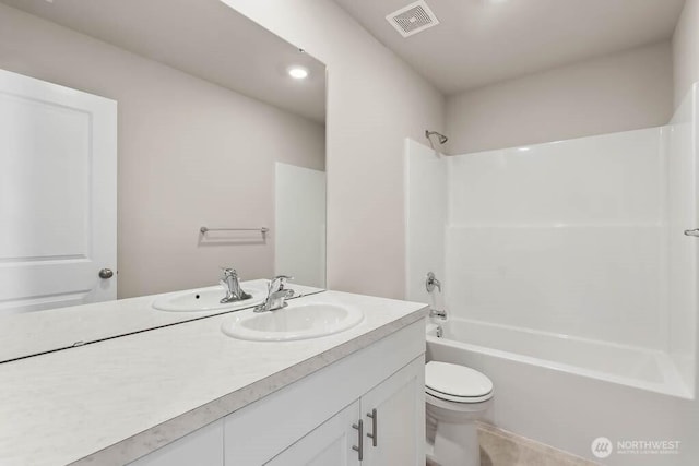 bathroom featuring visible vents, toilet, vanity, and shower / bath combination