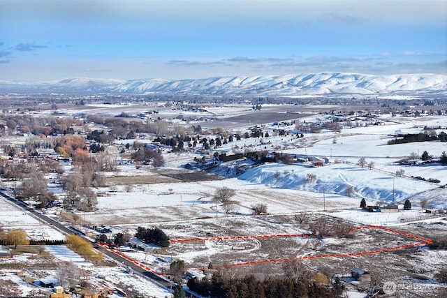 snowy aerial view with a mountain view