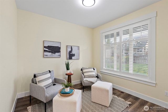 living area featuring baseboards and wood finished floors