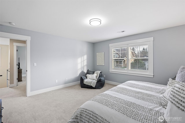 bedroom featuring light carpet, visible vents, and baseboards