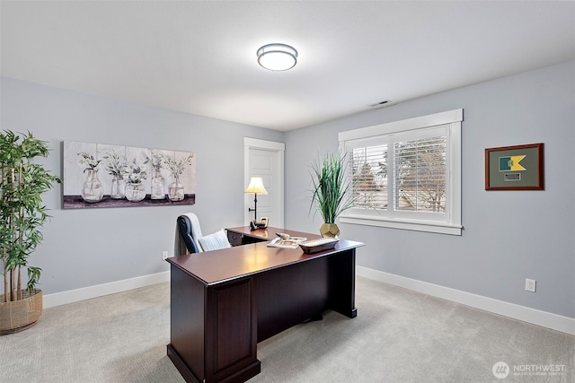 office space featuring light colored carpet, visible vents, and baseboards