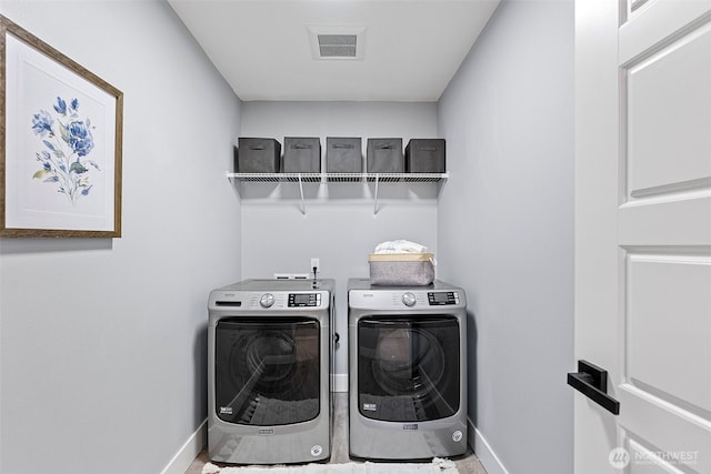 clothes washing area featuring laundry area, independent washer and dryer, visible vents, and baseboards