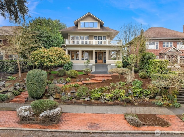 american foursquare style home featuring a balcony and a porch