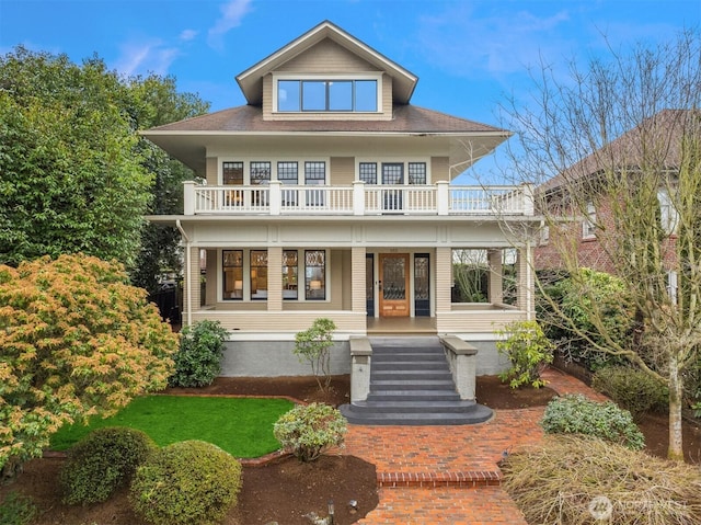 view of front of house featuring covered porch and a balcony