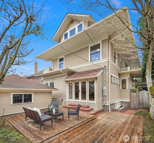 rear view of property featuring entry steps, a wooden deck, and an outdoor hangout area