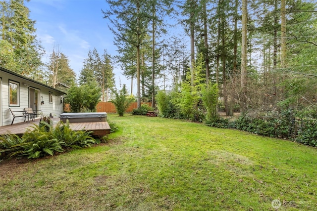 view of yard featuring a hot tub and a wooden deck