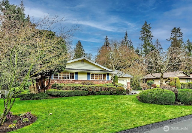 single story home with a garage, brick siding, and a front yard