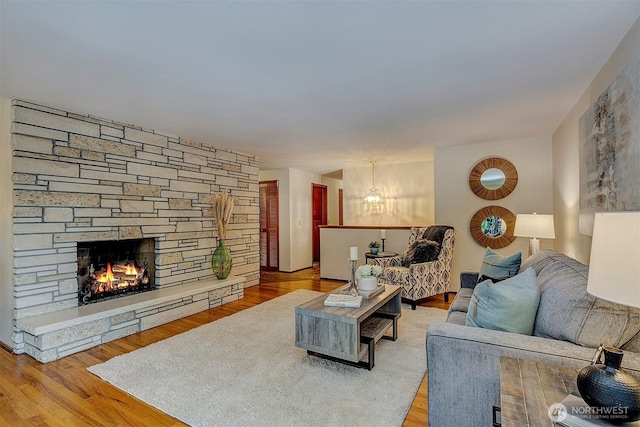 living room with a fireplace and wood finished floors