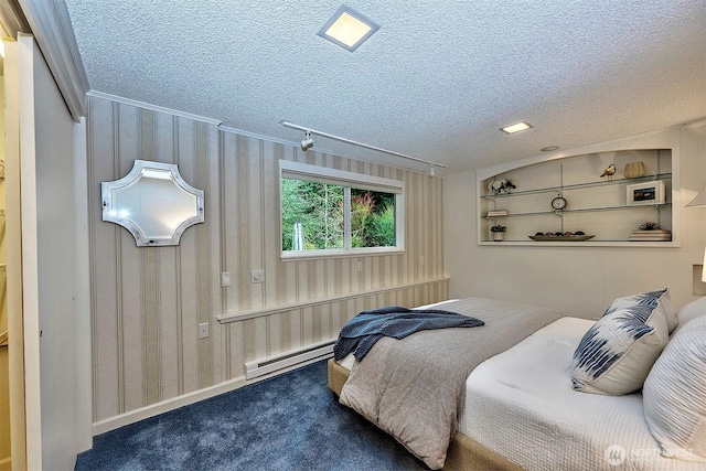 bedroom featuring baseboard heating, a textured ceiling, and carpet flooring