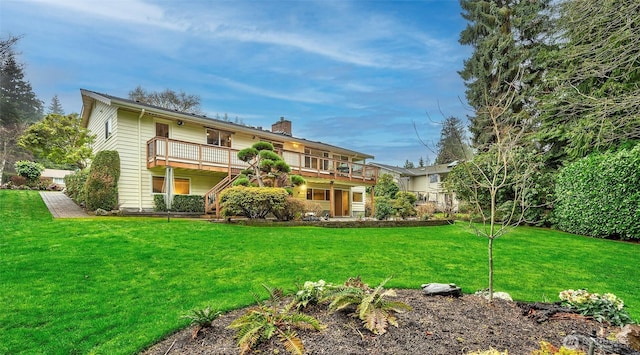 back of house with a yard, a chimney, and a balcony