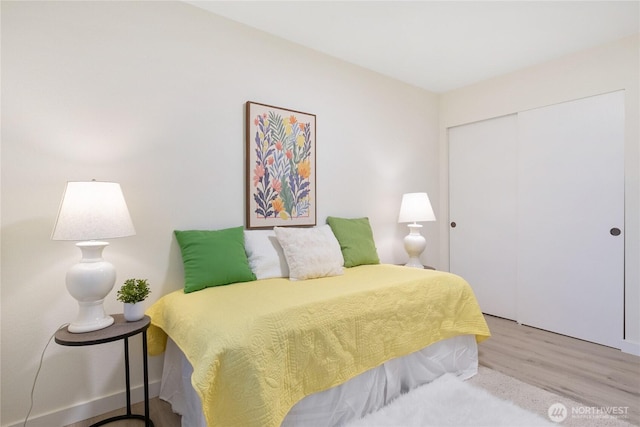 bedroom with a closet and wood finished floors