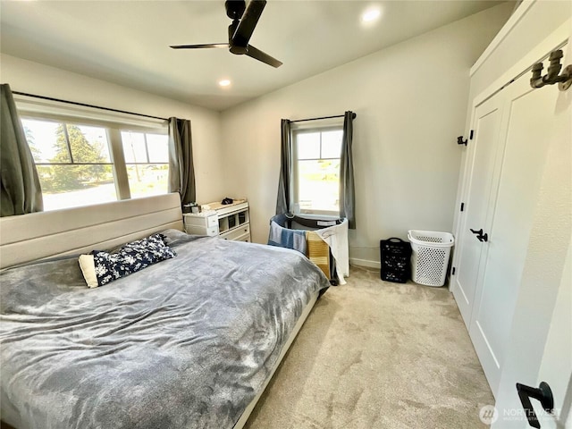 bedroom with light carpet, multiple windows, lofted ceiling, and recessed lighting