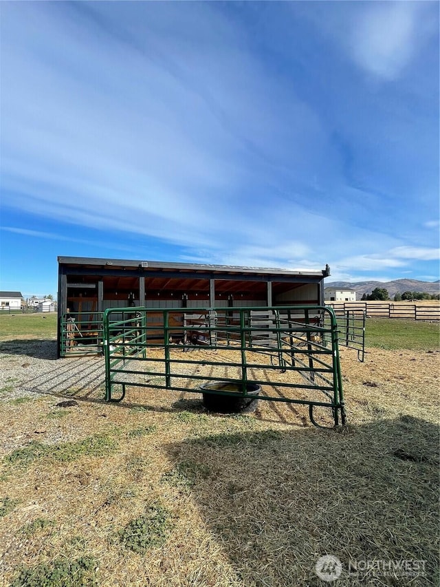 view of stable featuring a rural view