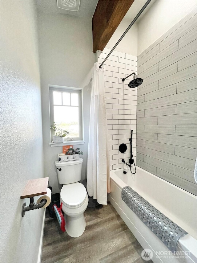 full bath with toilet, shower / bath combo, and wood finished floors