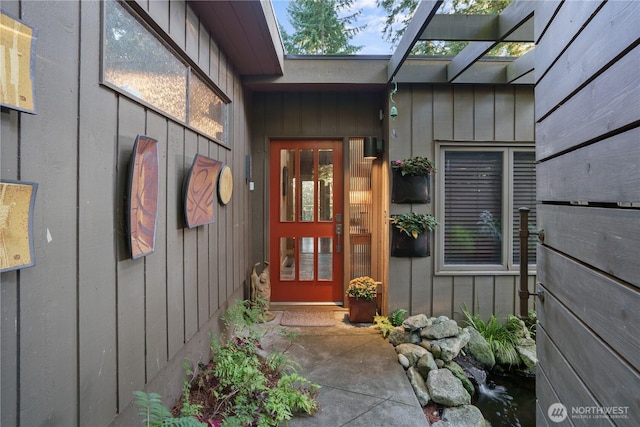 entrance to property featuring a patio and board and batten siding