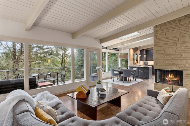 sunroom / solarium with beamed ceiling and a fireplace