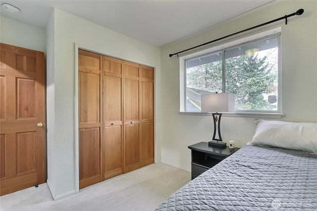 bedroom featuring light carpet and a closet