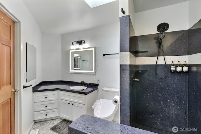 bathroom featuring a walk in shower, vanity, toilet, and marble finish floor