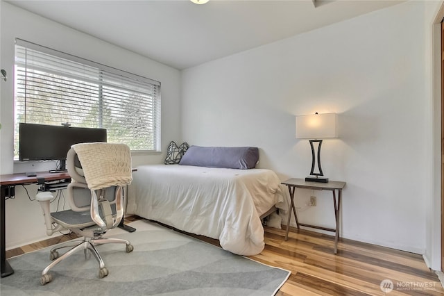 bedroom featuring wood finished floors
