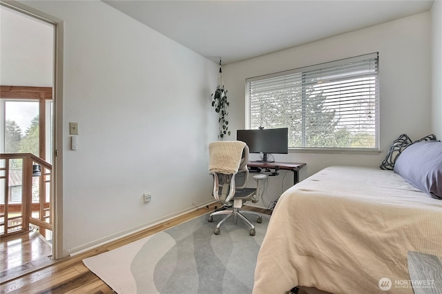 bedroom featuring baseboards and wood finished floors