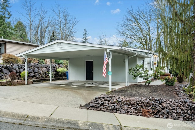 view of front of property featuring driveway and an attached carport