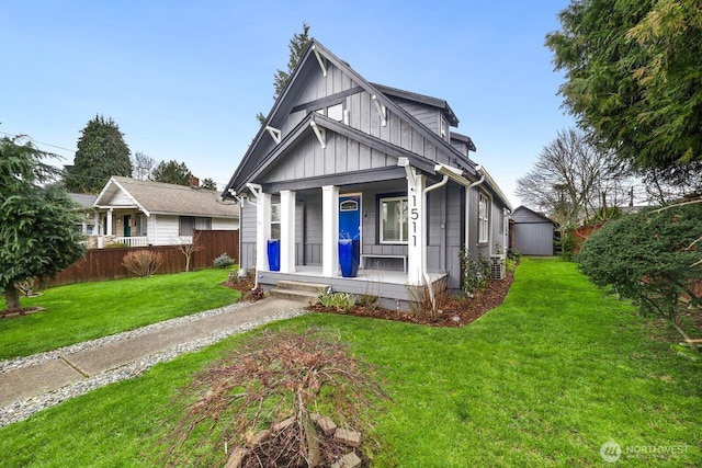 bungalow-style home with fence, a porch, board and batten siding, and a front yard