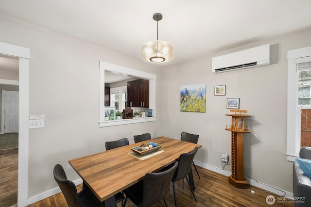 dining space featuring dark wood-style floors, plenty of natural light, and a wall mounted AC