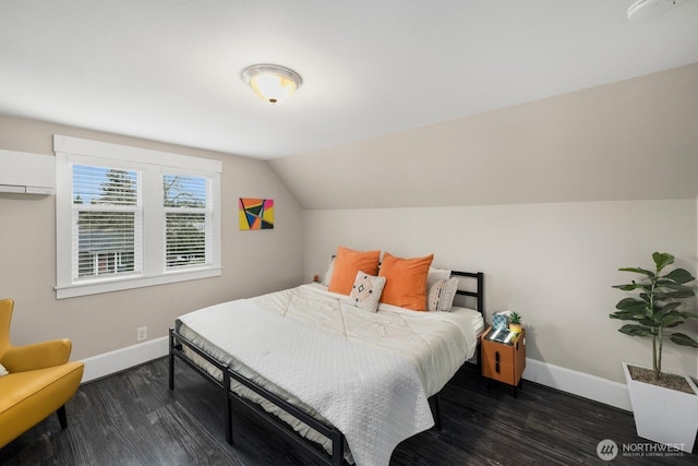 bedroom featuring lofted ceiling, dark wood-type flooring, a wall unit AC, and baseboards