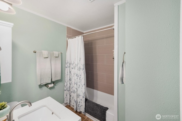 bathroom featuring a shower with shower curtain, a sink, and tile patterned flooring