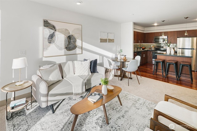 living area with wood finished floors and recessed lighting