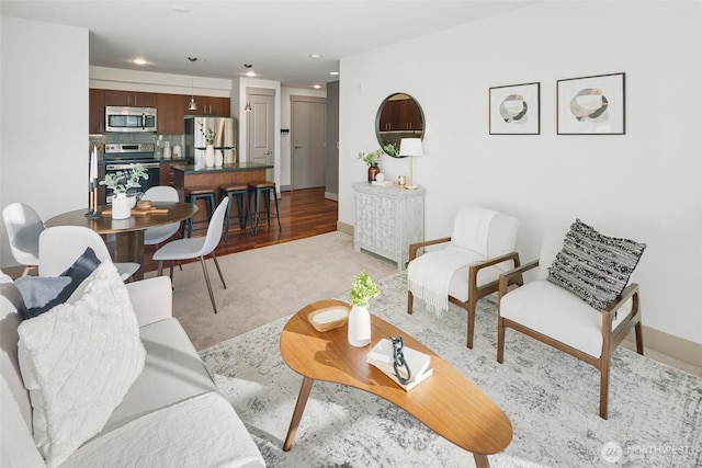 living room with baseboards and recessed lighting