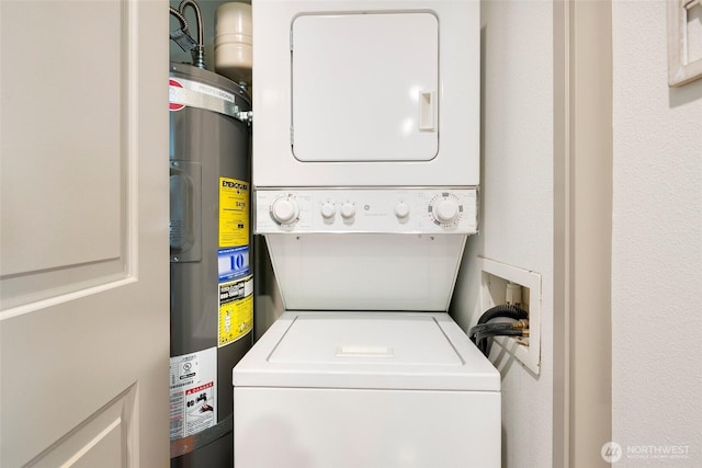 clothes washing area with laundry area, water heater, and stacked washing maching and dryer