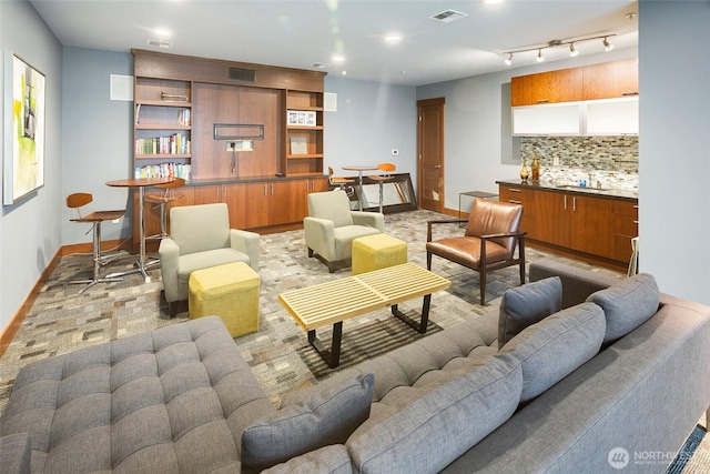 living room with baseboards and visible vents