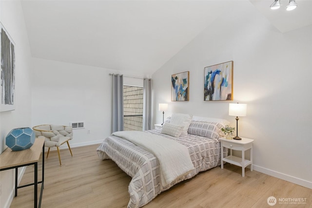 bedroom featuring light wood-type flooring, baseboards, visible vents, and lofted ceiling