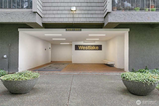 doorway to property featuring stucco siding