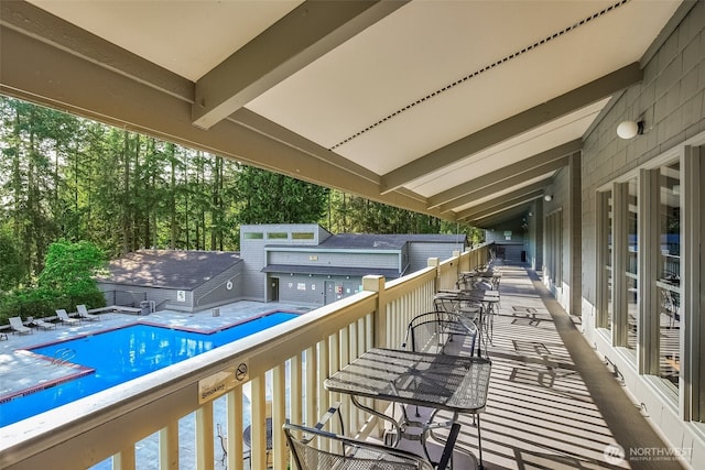 wooden terrace with a community pool