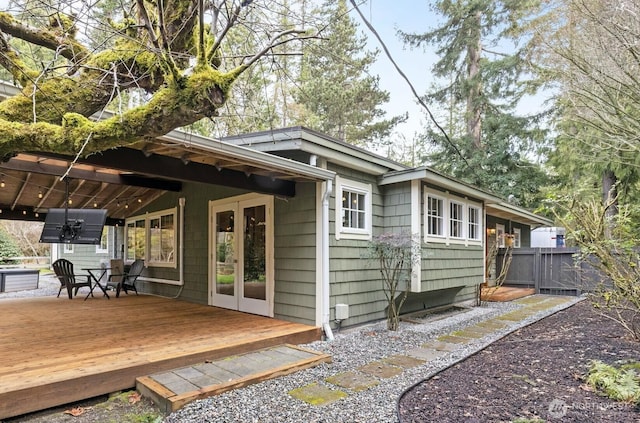 back of house featuring a wooden deck and fence