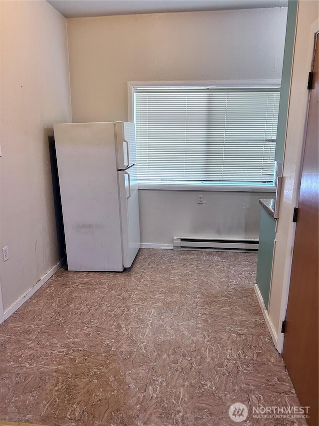 interior space with a baseboard radiator and white refrigerator