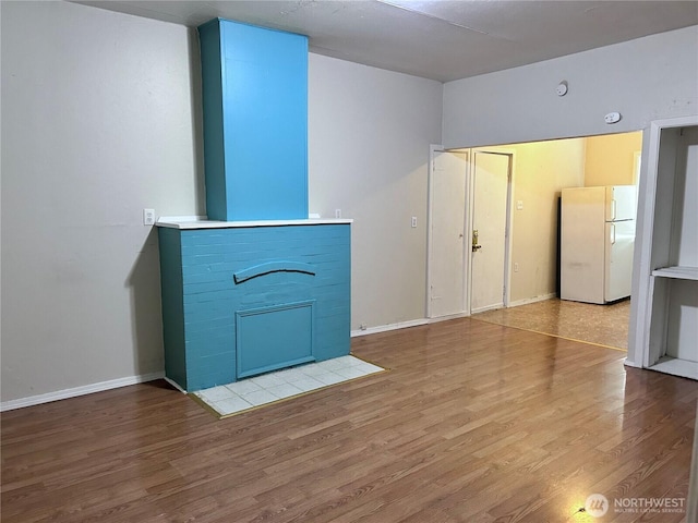 unfurnished living room with wood-type flooring