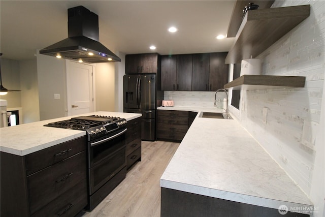 kitchen with a center island, double oven range, sink, island exhaust hood, and black fridge