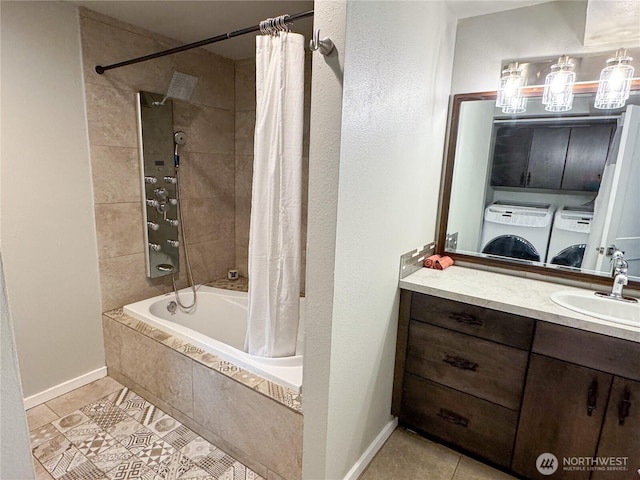 bathroom with shower / bath combo, tile patterned flooring, separate washer and dryer, and vanity