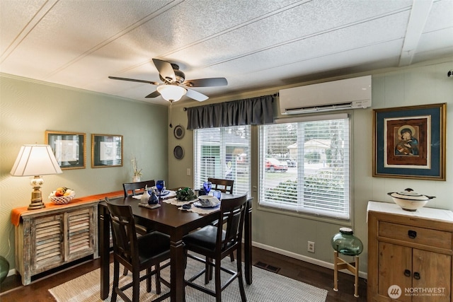 dining area with dark wood-type flooring, ceiling fan, a wall unit AC, and a textured ceiling