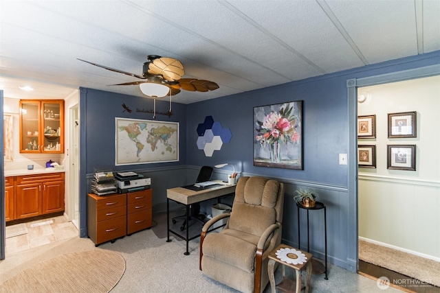 office area featuring light carpet and ceiling fan