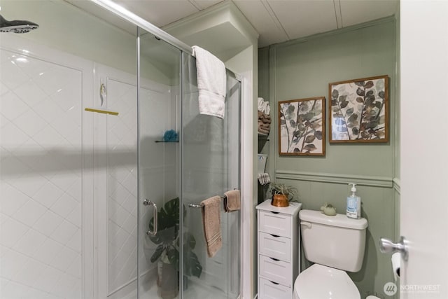 bathroom featuring an enclosed shower and toilet