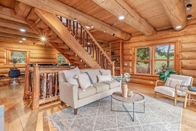 living room with stairs, beamed ceiling, wooden ceiling, and wood finished floors