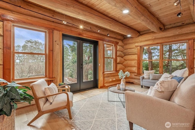 sunroom featuring french doors, beamed ceiling, and wood ceiling